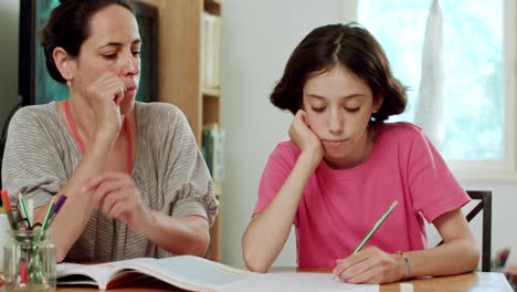 Mother-helping-her-teenage-daughter-to-do-her-homework