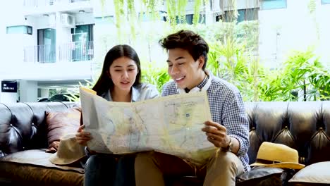 Tourist-couple-looking-at-the-map-in-the-lobby.