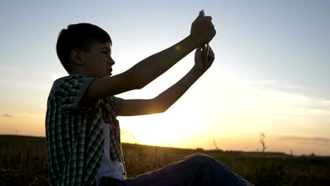 boy-in-a-hat-sits-on-top-and-talks-on-video-communication-using-a-tablet