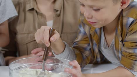 Boy-Cooking-Dough-with-Mom-and-Sister