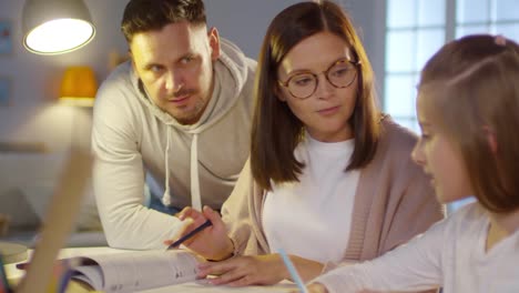 Mother-and-Father-Helping-Daughter-with-Homework