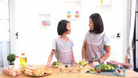 Mother-and-daughter-cooking-in-the-kitchen-at-home,-happy-family-asian-concept