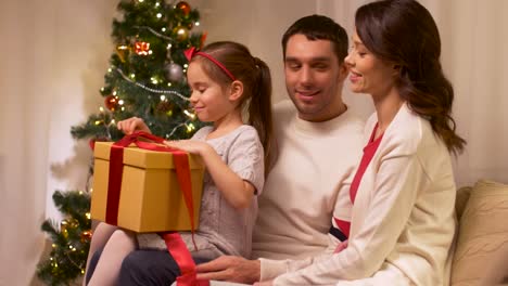 happy-family-with-christmas-present-at-home