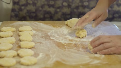 Making-dough-pieces-with-woman's-hands-at-home.