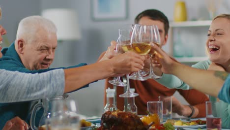 Big-Family-and-Friends-Celebration-at-Home,-Diverse-Group-of-Children,-Young-Adults-and-Old-People-Gathered-at-the-Table-have-Fun-Conversation.-Clinking-Glasses-and-Making-Toast.-In-Slow-Motion.