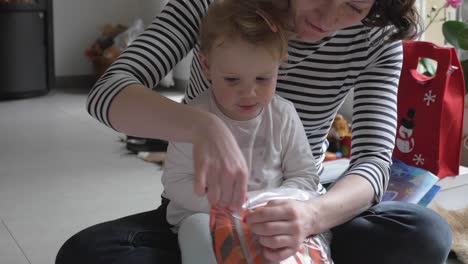 Toddler-and-Mother-Opening-Christmas-Presents