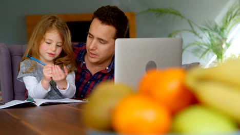 Father-helping-girl-in-her-studies-in-living-room-4k