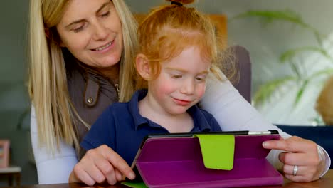 Mother-and-son-using-digital-tablet-at-home-4k