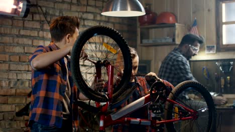 Father-and-his-two-sons-repairing-a-bike