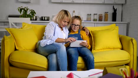 Chatting-mom-and-daughter-networking-with-tablet-pc