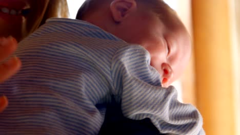 Mother-consoling-her-baby-boy-in-living-room-4k