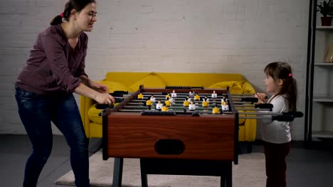 Mom-and-special-needs-child-enjoying-table-soccer
