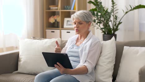 senior-woman-having-video-chat-on-tablet-pc