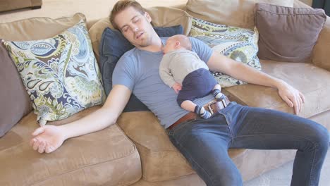 Father-and-newborn-son-asleep-on-couch