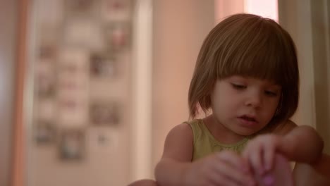 A-little-girl-in-a-hallway-putting-her-shoes-on