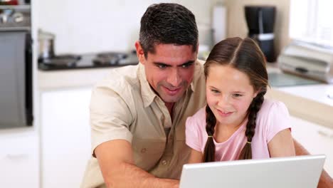 Father-using-the-laptop-with-his-daughter