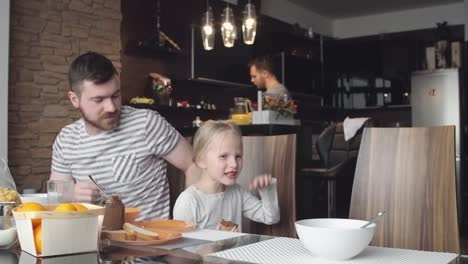 Gay-parent-talking-with-little-daughter-at-breakfast