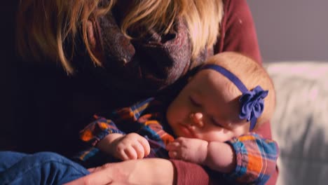 A-baby-being-bounced-to-sleep-by-her-mother-on-a-yoga-ball-in-a-nursery