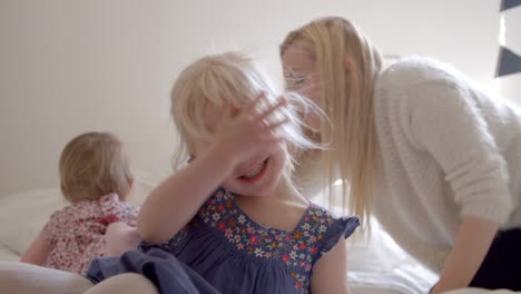 Daughters-Having-Fun-Jumping-On-Parents-Bed-In-Slow-Motion