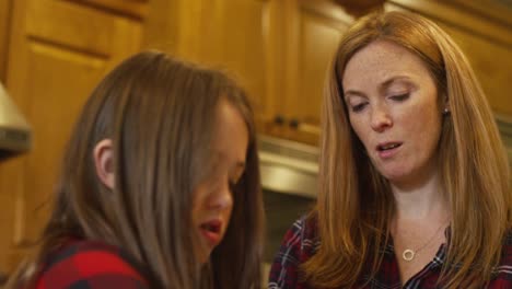 A-mother-helping-her-daughter-in-the-kitchen