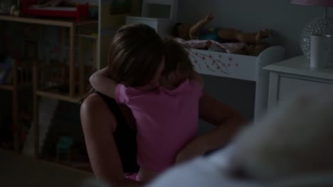 A-little-girl-giving-her-mom-a-big-hug-in-the-morning-after-waking-up