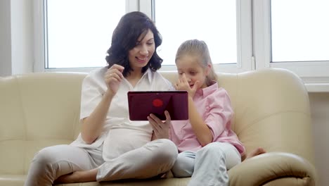 Mother-and-daughter-using-a-tablet-computer.