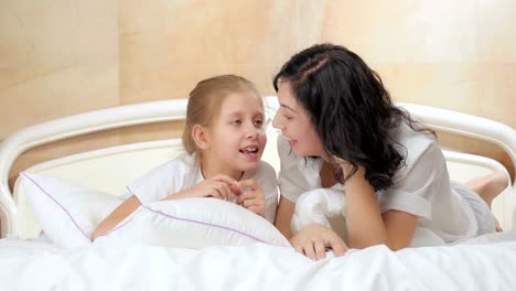 Young-mother-and-little-daughter-talking.