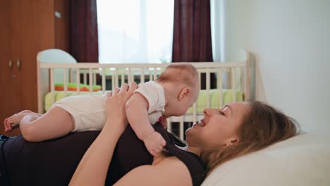 Mother-Plays-with-Her-Baby-laying-on-mom's-stomach