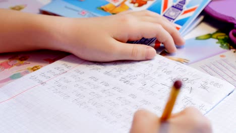 Pretty-little-girl-is-learning-to-write-at-the-table