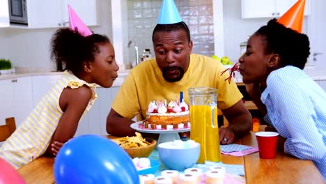 Family-celebrating-a-birthday-in-kitchen-at-home