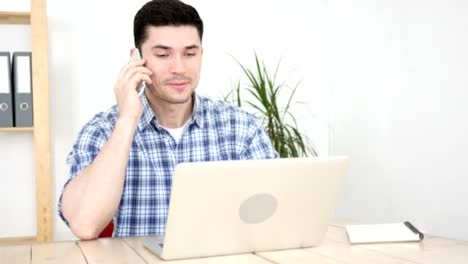 Man-Talking-on-Phone-in-His-Office,-Communication