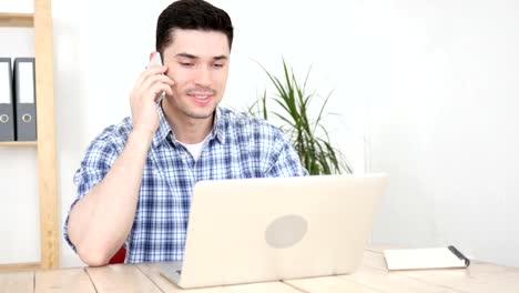 Man-Talking-on-Phone-in-His-Office,-Communication