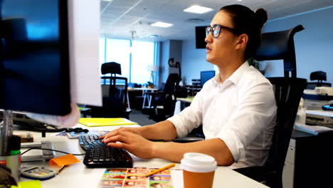 Male-graphic-designer-working-at-desk