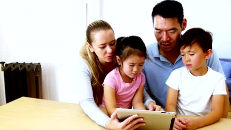 Happy-family-using-digital-tablet-in-living-room