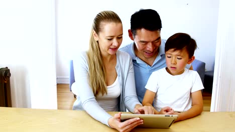 Happy-family-using-digital-tablet-in-living-room