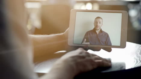 Man-Communicating-With-Digital-Tablet.-Friends-Having-Fun-Talking-Via-Video-Chat.