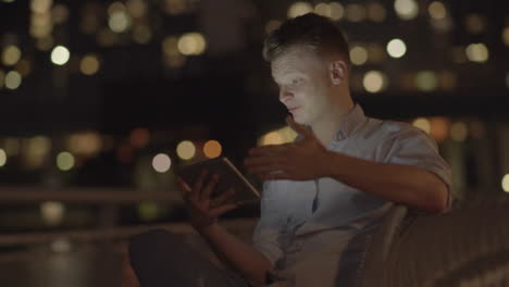 Young-Blond-Man-Having-a-Video-Conference-Via-Digital-Tablet.-Smiling-and-Communicating-to-his-Friend-and-Colleague.