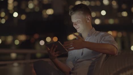 Young-Blond-Man-Having-a-Video-Conference-Via-Digital-Tablet.-Smiling-and-Communicating-to-his-Friend-and-Colleague.