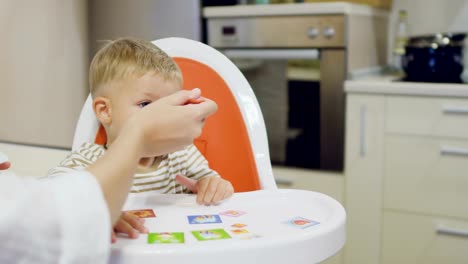 Mom-feeds-pretty-child-with-the-yogurt