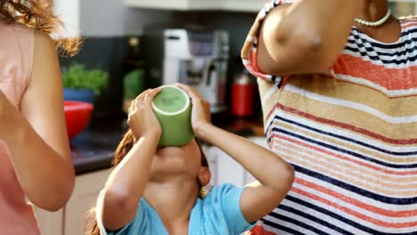 Mother,-daughter-and-granny-having-a-drink-in-the-kitchen-4K-4k