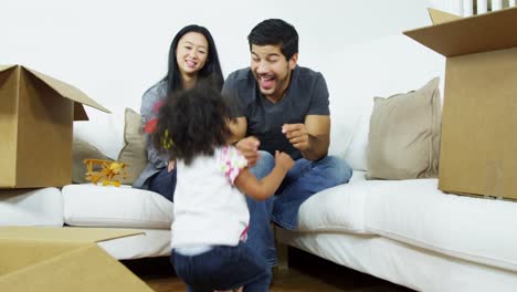 Happy-Asian-Chinese-family-surrounded-home-moving-boxes