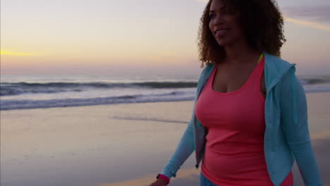 Afro-haired-Ethnic-female-exercising-with-wearable-technology