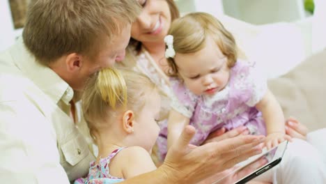 Parents-and-girls-playing-on-tablet-at-home