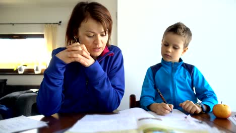 Mother-and-child-doing-school-homework,-4K-resolution