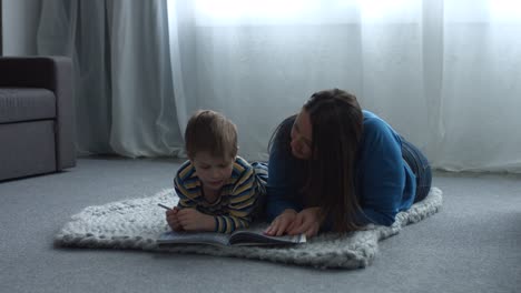 Single-mother-helping-her-cute-son-with-homework