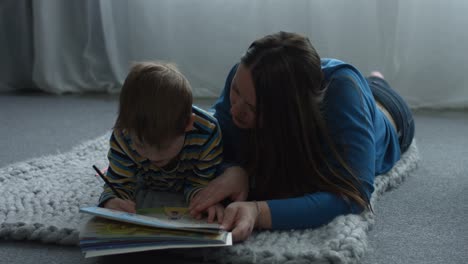 Caring-mom-helping-son-drawing-in-coloring-book