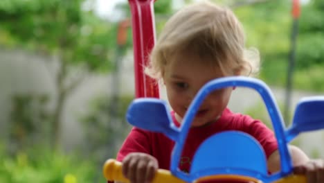 Toddler-baby-boy-playing-with-car-toy-automobile