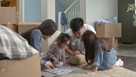 Parents-and-Children-Looking-at-Layout-Plan-of-New-House