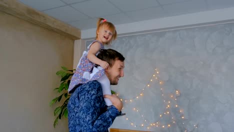 Young-father-spinning-his-happy-daughter