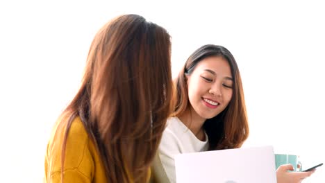 Young-asian-lesbian-LGBT-couple-using-laptop-on-bed-room-at-home.